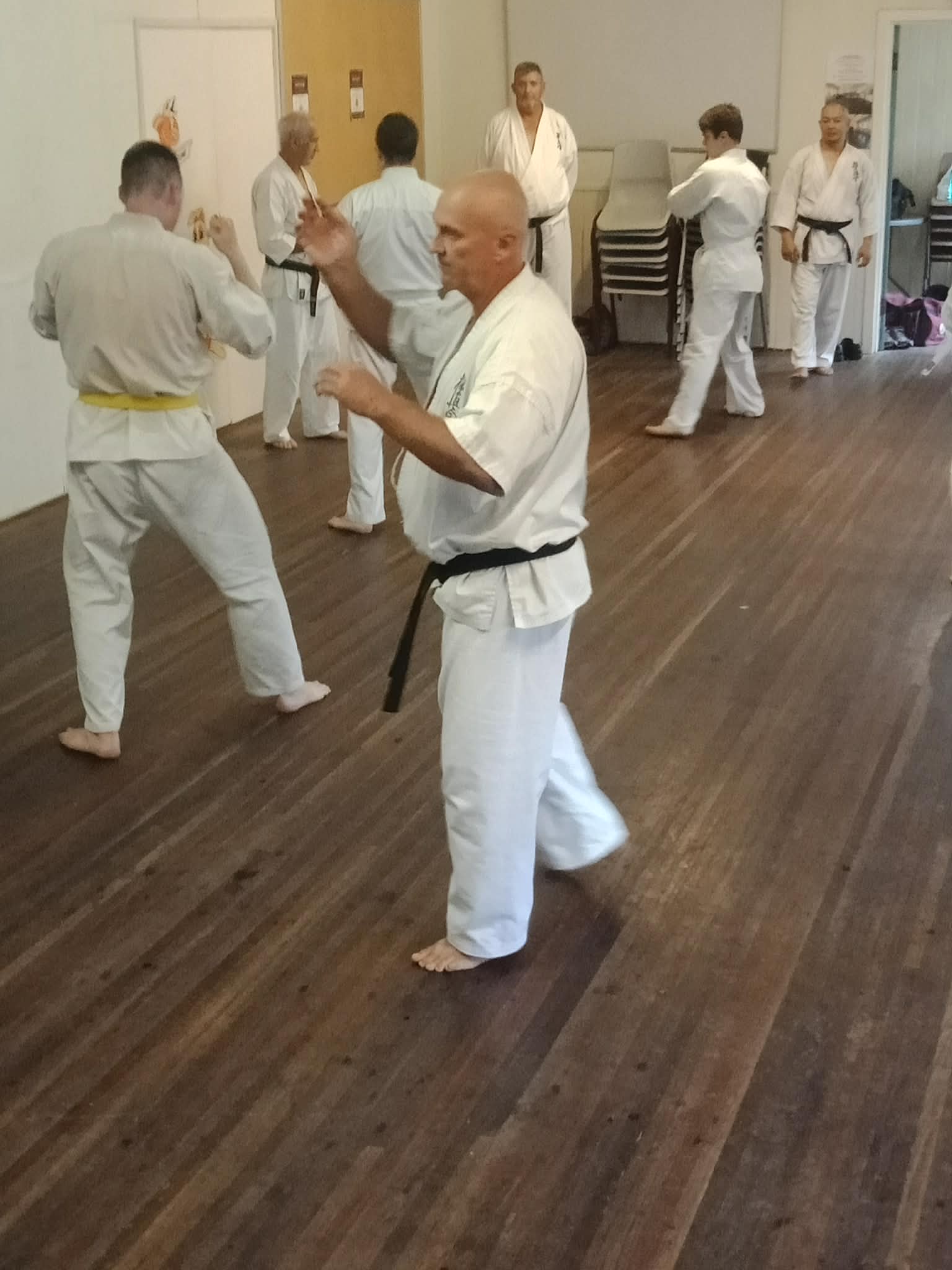 Karate class practicing guard and movement drills